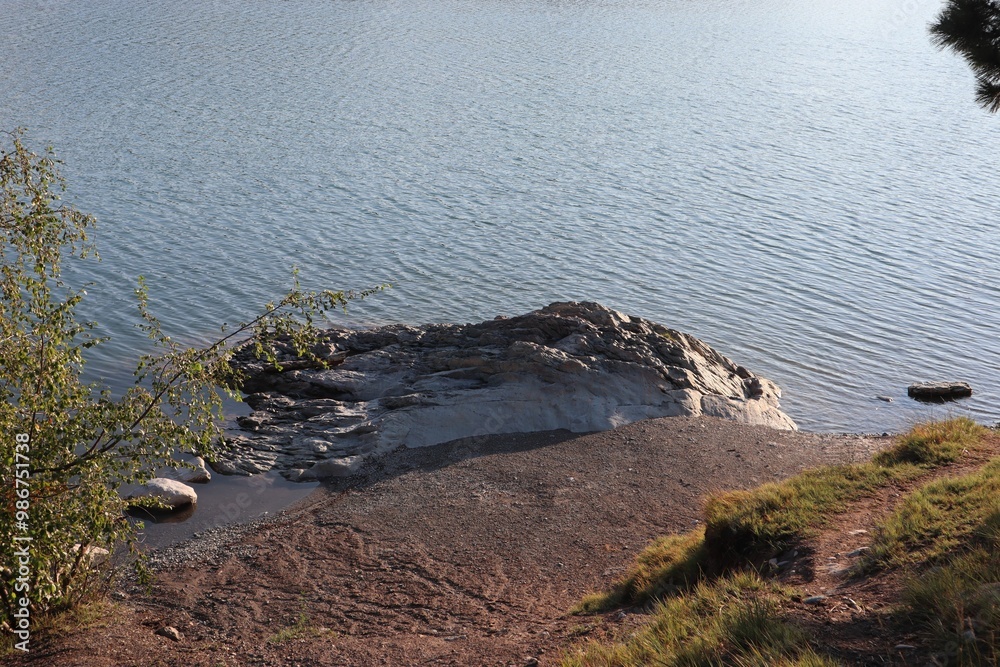Fototapeta premium The shore of Foys Lake on a sunny day in the city of Kalispell's, Montana, United States