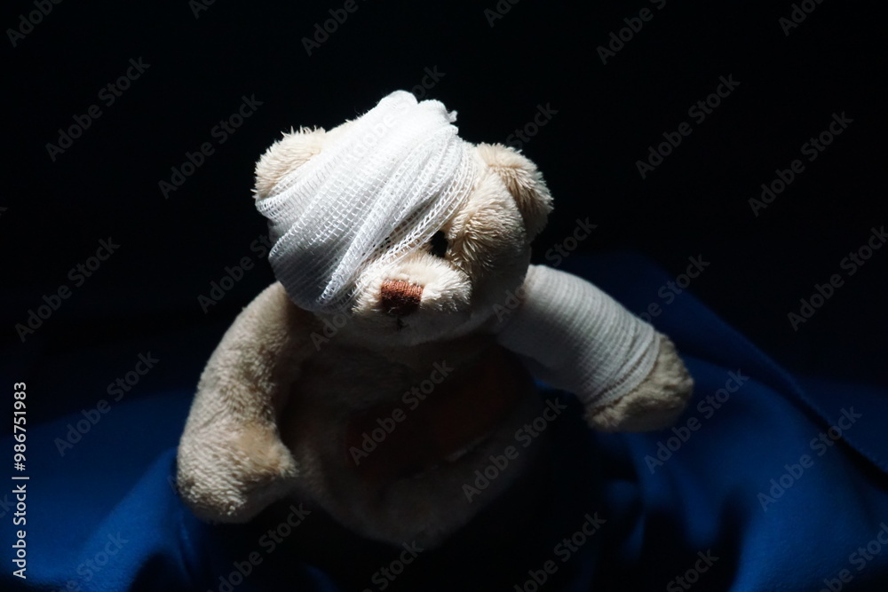 Injured sick teddy bear bandaged with bandage and plaster. Trauma that ...