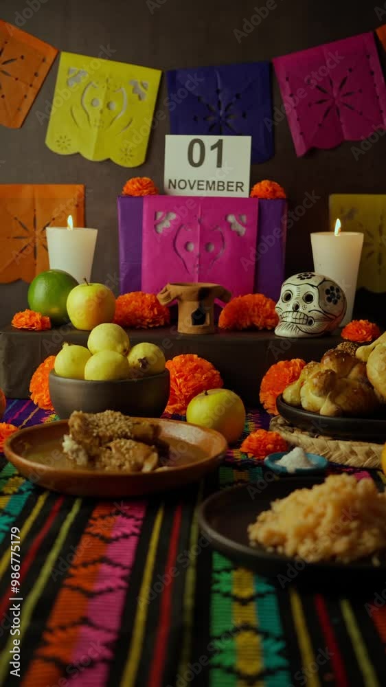 Vertical video, Day of the Dead altar in Mexico, in the background the hand of a Mexican woman places a sign with the date November 1st Vertical video, Day of the Dead altar in Mexico, in the background the hand of a Mexican woman places a sign with the date November 1st