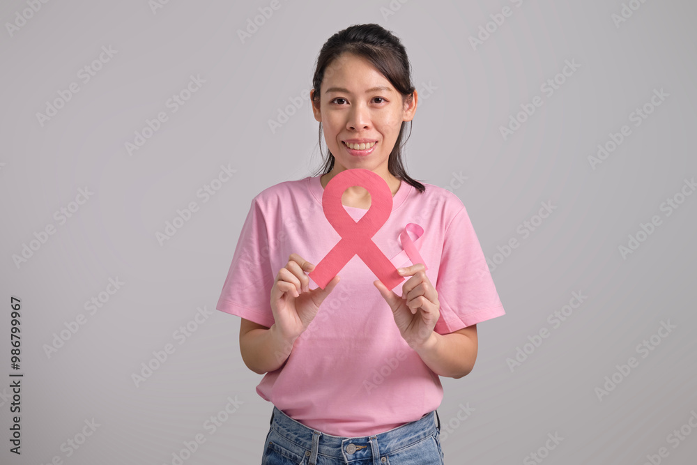 Young woman with pink ribbon. Breast cancer awareness concept. Young woman with pink ribbon. Breast cancer awareness concept.