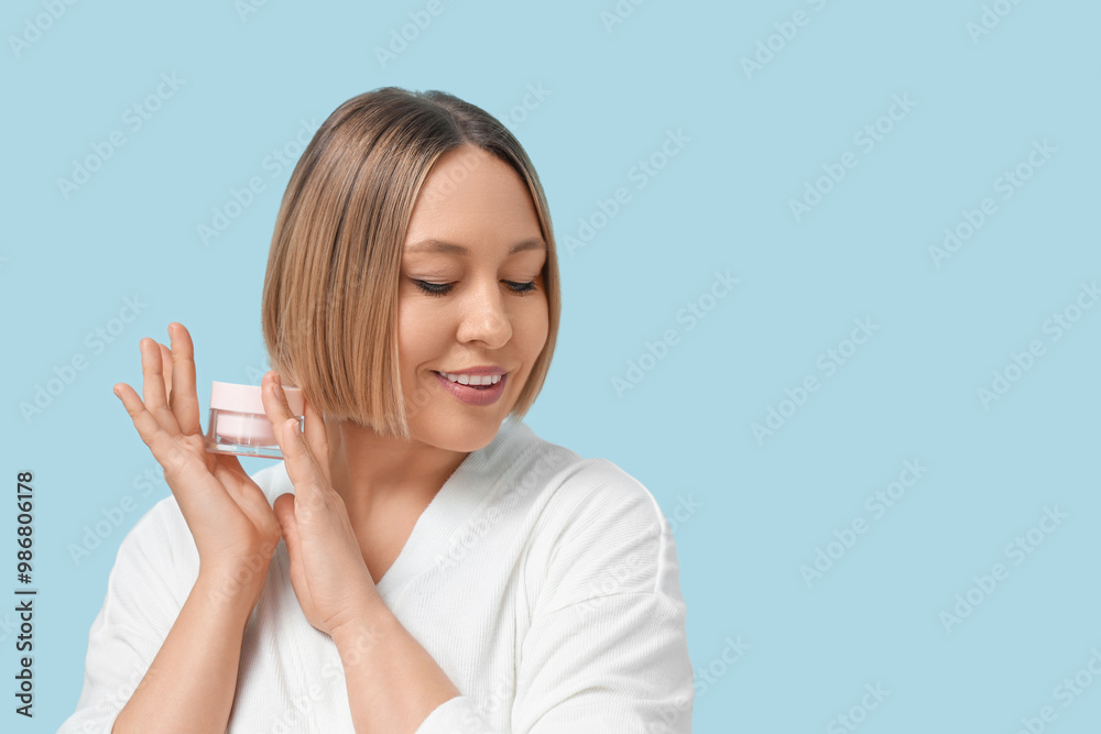 Mature woman holding jar of cream on color background Mature woman holding jar of cream on color background