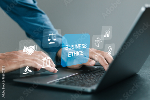 Business ethics behavior and manners concept. Businessman using laptop with business ethics icons on virtual screen. ethical corporate culture, business integrity and moral.