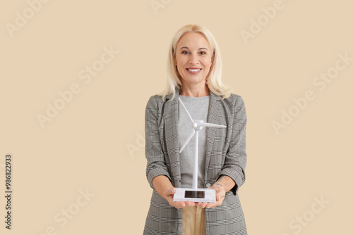Mature woman with wind turb...