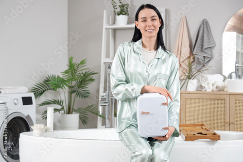 Smiling woman in pajamas ho...
