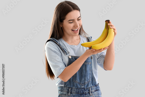 Young woman with bananas on...