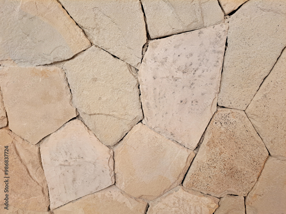 Beige cream flagstone or limestone slab random cut on a floor and wall. Seamless natural beige stone background texture. Beige cream flagstone or limestone slab random cut on a floor and wall. Seamless natural beige stone background texture.