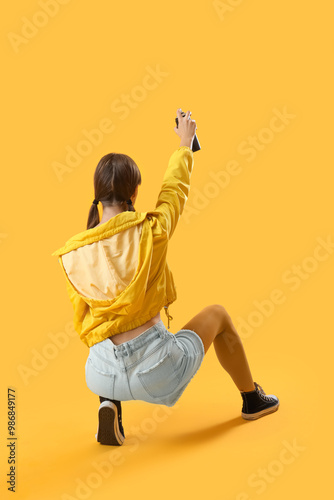 Young girl with spray can o...