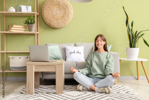Pretty young woman meditati...