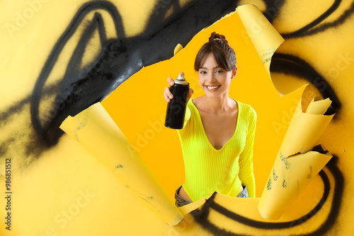 Young girl with spray can o...