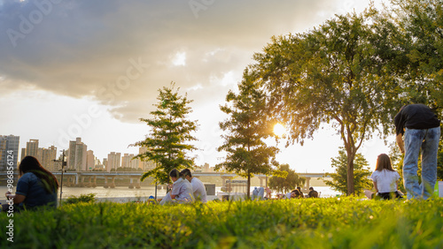 People enjoying a picnic at Hangang Park at sunset