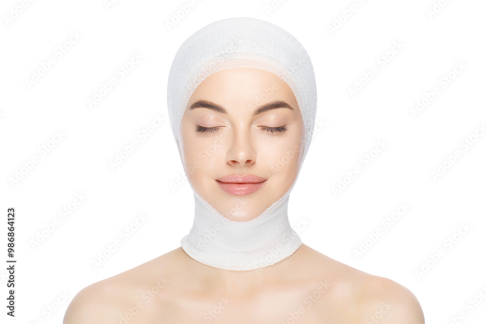 Young beautiful woman standing with closed eyes, wrapped in medical bandage, getting ready for plastic surgery operation Young beautiful woman standing with closed eyes, wrapped in medical bandage, getting ready for plastic surgery operation