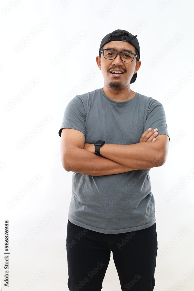 Fototapeta premium Young handsome man with beard wearing casual glasses over white background happy face smiling with crossed arms looking at the camera. Positive person.