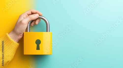 Yellow Padlock Held Against Colorful Background