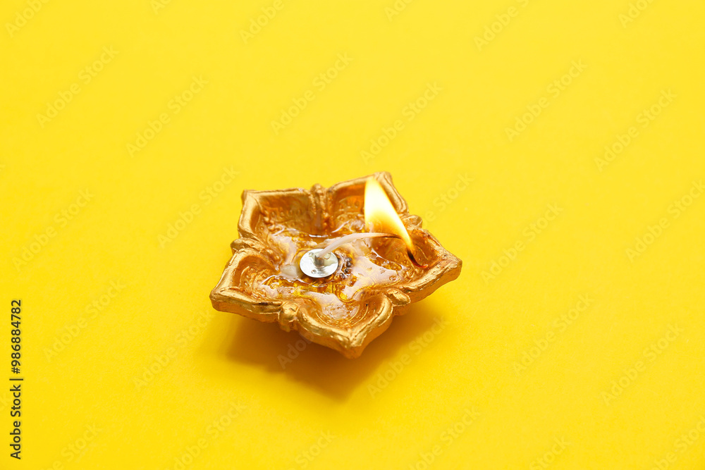Diya lamp on yellow background. Divaly celebration Diya lamp on yellow background. Divaly celebration
