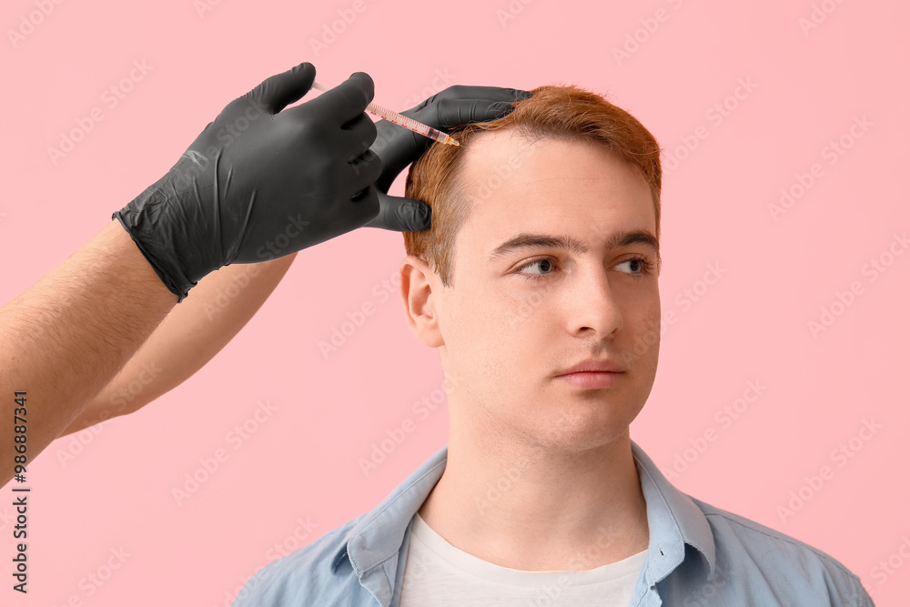 Young redhead man with hair loss problem receiving injection on pink background, closeup Young redhead man with hair loss problem receiving injection on pink background, closeup