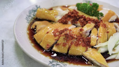 Close-up view of the traditional Hainanese chicken with cucumber