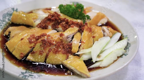 Close-up view of the traditional Hainanese chicken with cucumber