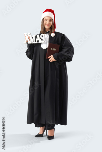 Female judge in Santa hat w...