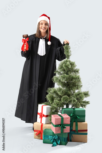 Female judge in Santa hat w...