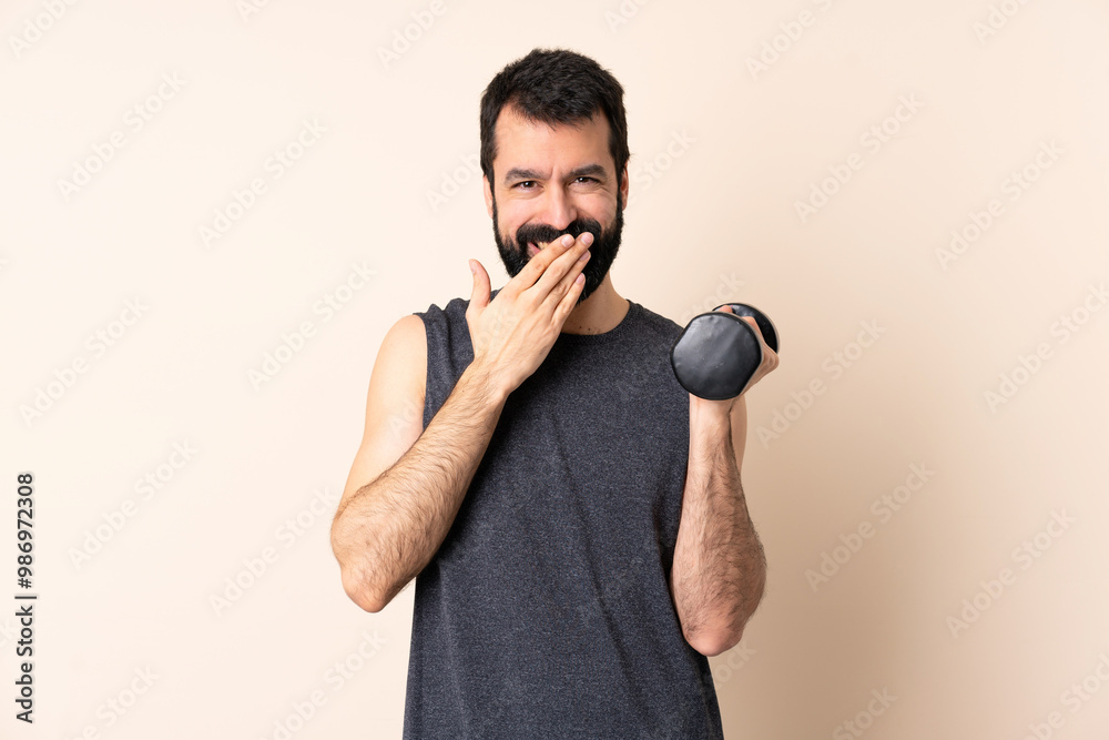 Caucasian sport man with beard making weightlifting over isolated background happy and smiling covering mouth with hand Caucasian sport man with beard making weightlifting over isolated background happy and smiling covering mouth with hand