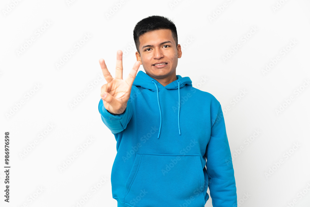Young Ecuadorian man isolated on white background happy and counting three with fingers Young Ecuadorian man isolated on white background happy and counting three with fingers