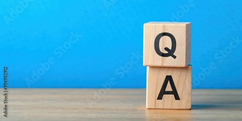 Close up shot of Q and A wooden blocks on blue background with copy space for questions and answers concept