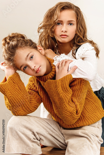 Two girls sisters portrait in the studio.