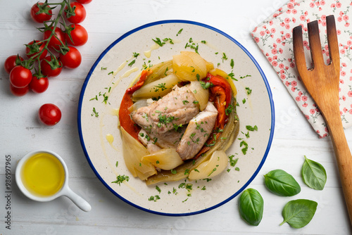 Baked mackerel with escalivada vegetables, peppers, onions and eggplant. Top view table with decoration. photo