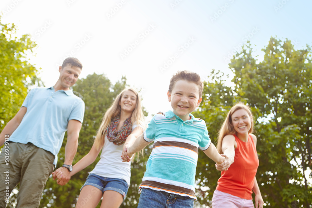 Kid, family and holding hands in nature for portrait, trust and fun activity on adventure in Australia. Parents, children and excited boy in park for game, playful and energy on holiday or vacation Kid, family and holding hands in nature for portrait, trust and fun activity on adventure in Australia. Parents, children and excited boy in park for game, playful and energy on holiday or vacation