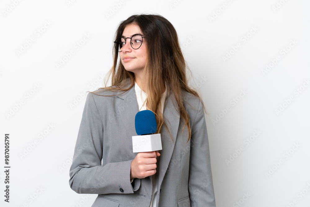 Young caucasian TV presenter woman isolated on white background looking to the side Young caucasian TV presenter woman isolated on white background looking to the side