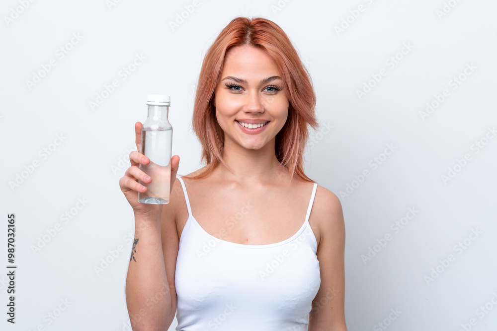 Young Russian girl with a bottle of water isolated on white background smiling a lot Young Russian girl with a bottle of water isolated on white background smiling a lot