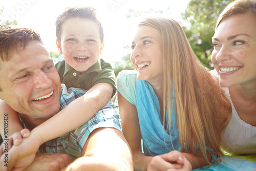 Picnic, outdoor and portrait of family, nature and bonding with children, hug and parents in park. Embrace, mom and dad with kids, relax and break in weekend, happy and man with woman and together