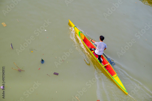 a man rowing a canoe on a river. photo