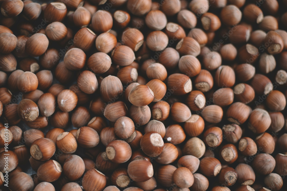 Hazelnuts in a wooden bowl on rustic background, Hazelnut background with green leaf Hazelnuts in a wooden bowl on rustic background, Hazelnut background with green leaf