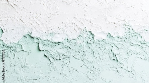 Pale mint green to white gradient with a rough, uneven texture, offering a light and refreshing background design. photo