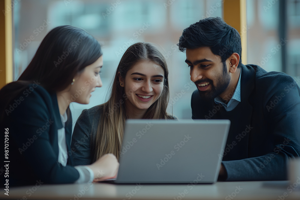 Diverse group of business professionals reviewing paper financial reports, reading through legal documents, working on agreement at laptop, sharing ideas, and laughing while doing paperwork