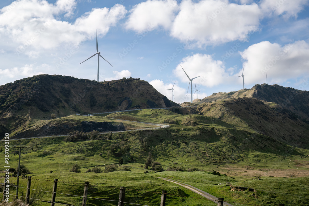 Windfarm on top of the hill under a fluffy cloud sky. Hawke's Bay. New Zealand.