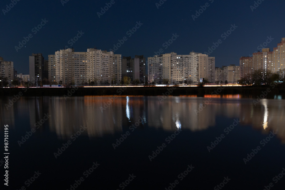 Fototapeta premium Night Skyline with lights on the evening lake, Kyiv, Ukraine