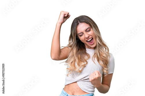 Young Uruguayan woman over isolated background celebrating a victory