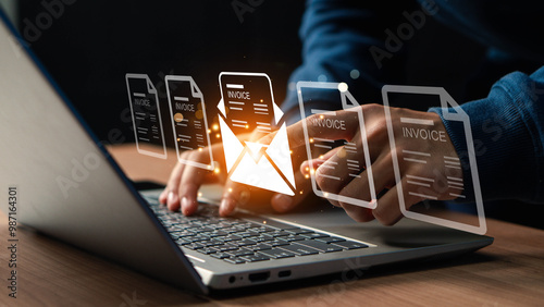 E-invoice and online digital statements concept. Businessman using computer laptop with invoice icons on virtual screen.