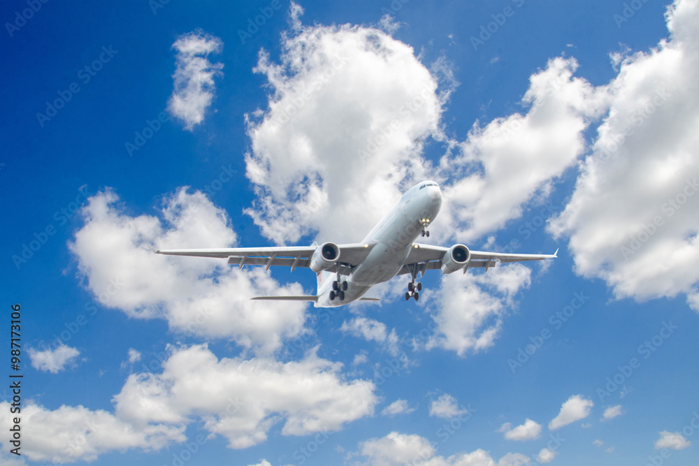 Fototapeta premium White passenger airplane flying in the sky amazing clouds in the background - Travel by air transport. High quality photo