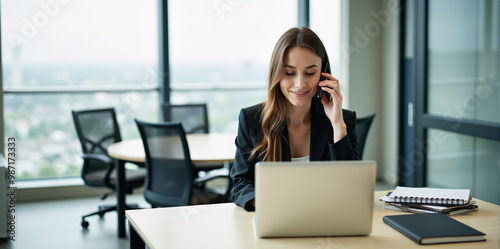 A  business woman is discussing a new strategy over the phone in a bright and productive office (with copy space).