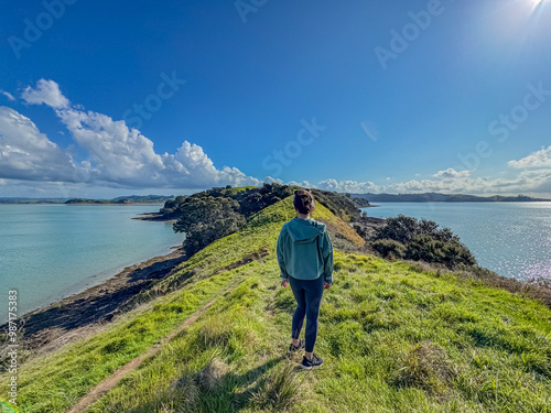 View of a park in New Zealand. Blue ocean and green grass field on spring day. Duder Park.