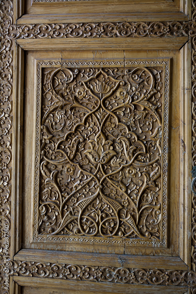 Detail of a carved wooden door entrance to a madrassa at the Registan in Samarkand Detail of a carved wooden door entrance to a madrassa at the Registan in Samarkand
