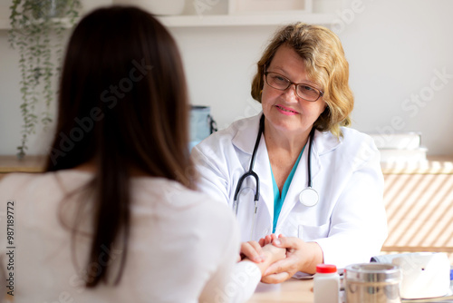 Senior woman doctor examining elderly while holding arm for pulse sitting in modern medical office, doctor checkup patient, patient and insurance, medical and health, doctor discussing with patient.