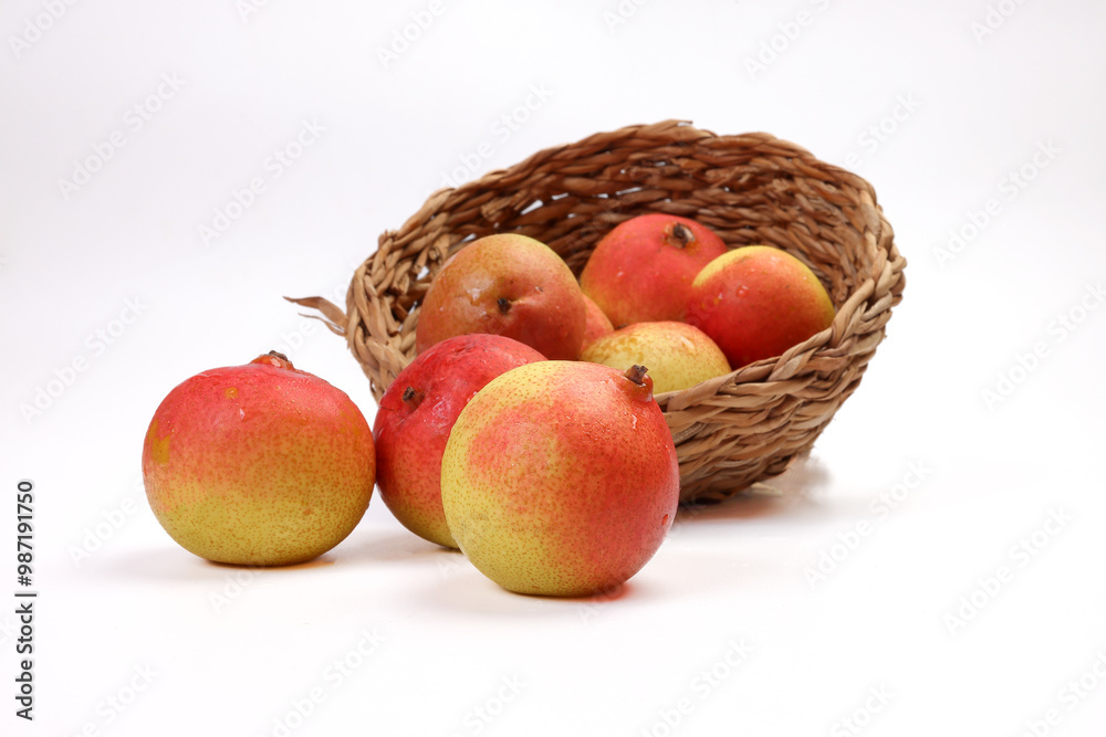 Green yellow red ripe mini pear sweet juicy on white background basket fork Green yellow red ripe mini pear sweet juicy on white background basket fork