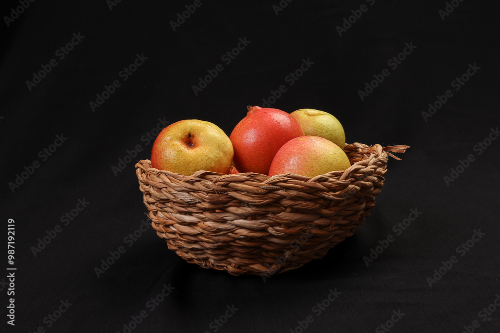 Green yellow red ripe mini pear sweet juicy in basket on wooden table dark background Green yellow red ripe mini pear sweet juicy in basket on wooden table dark background