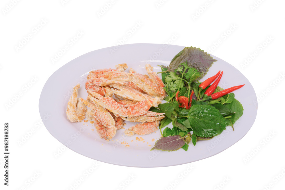 a plate of salted sentinel crab claws accompanied by fresh herbs and red chilies on a white background. The dish looks appetizing and well-presented, highlighting its gourmet appeal. a plate of salted sentinel crab claws accompanied by fresh herbs and red chilies on a white background. The dish looks appetizing and well-presented, highlighting its gourmet appeal.