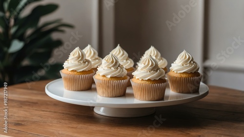 set of elegant white design cupcakes on aesthetic wooden table background photo