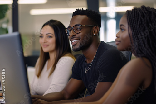 A diverse team, including Black and Hispanic professionals, working together in a collaborative modern office.